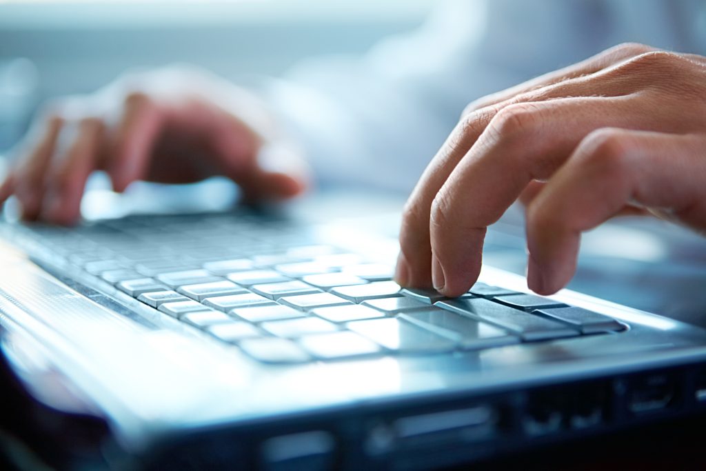 fingers typing on keyboard