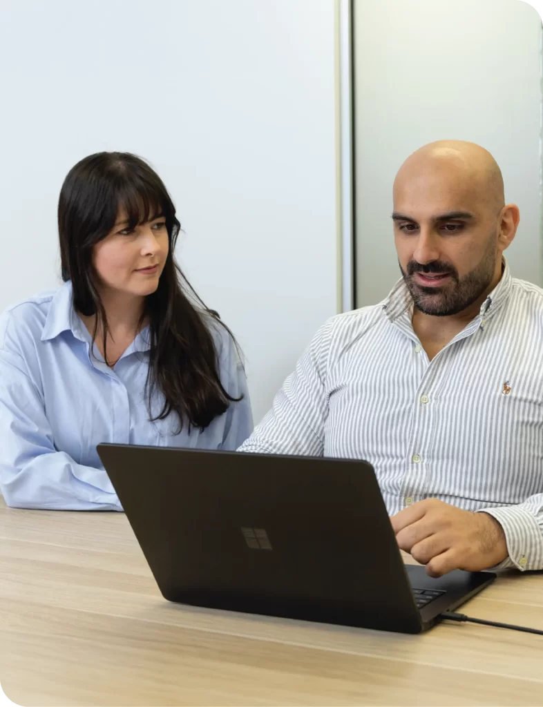 Sarah and Joe working at a laptop