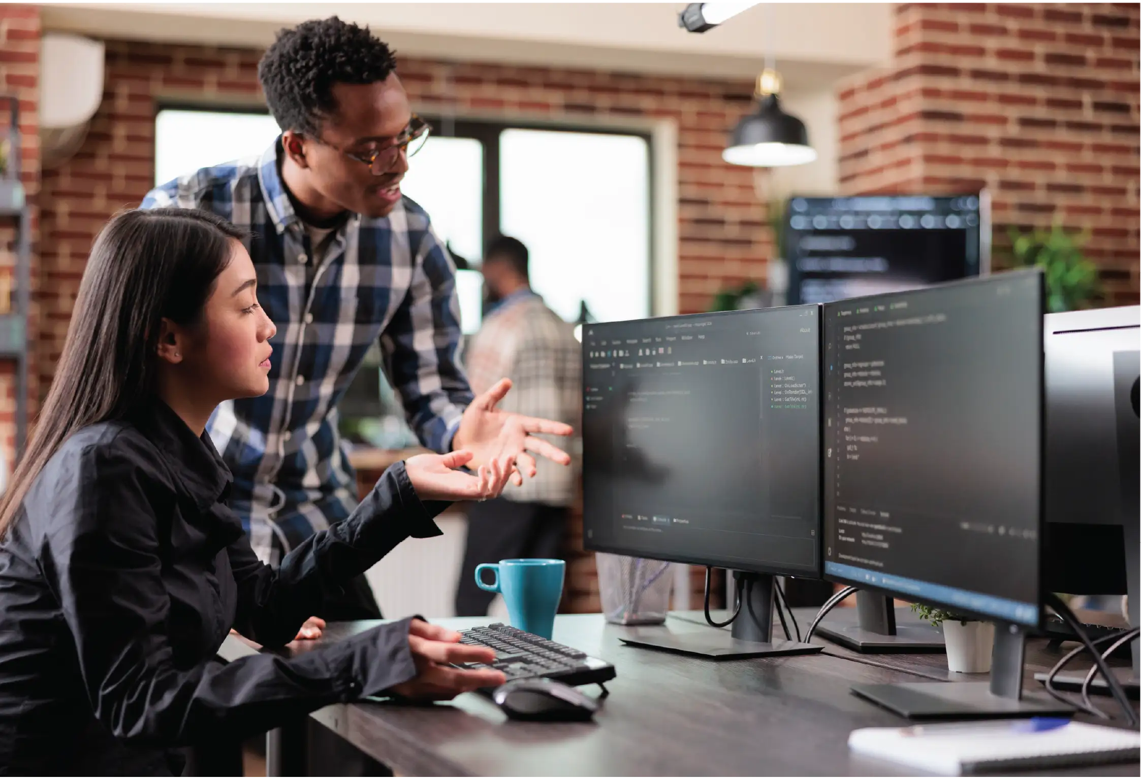 two people mid conversation and looking an a computer