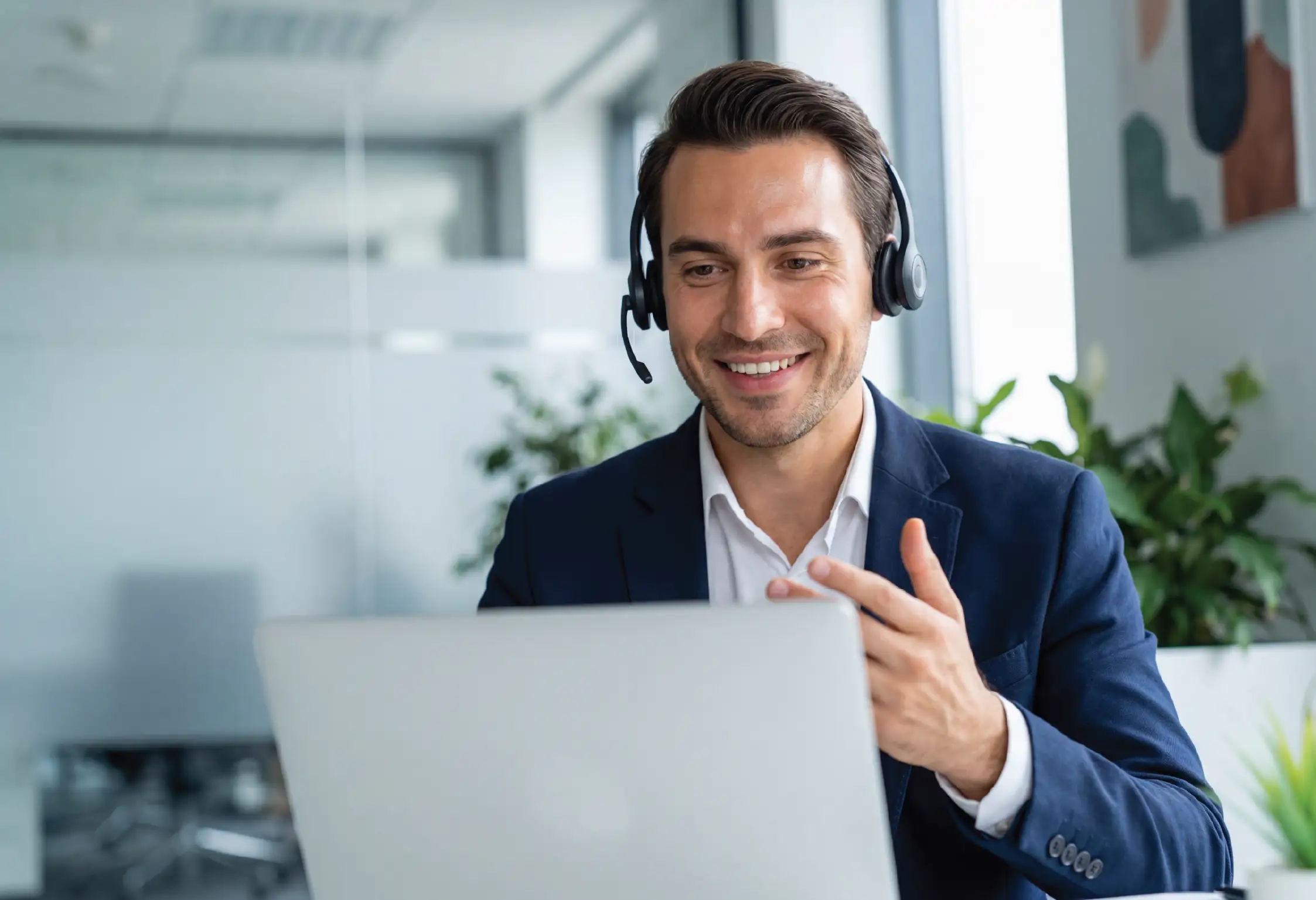 a man wearing a headset and smiling while on a phone call